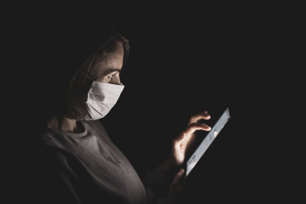 Woman Wearing Mask using iPad