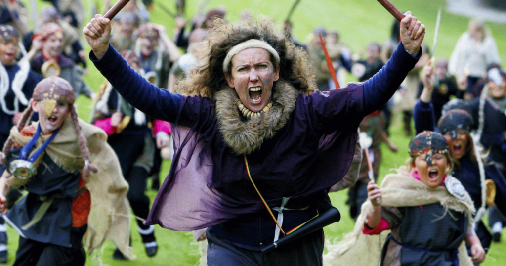 Mags Bryne with primary school pupils staging a mock Viking invasion of Stormont as part of Reach.In Out programme, 2007.